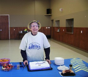 Trefoil Guild member celebrating with a cake.